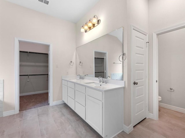 4203 Chloe Ridge Ln, Fulshear, TX 77441 - full bathroom featuring toilet, double vanity, a sink, and a spacious closet