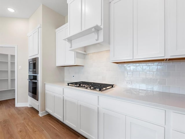 4203 Chloe Ridge Ln, Fulshear, TX 77441 - kitchen featuring white cabinetry, stainless steel appliances, light wood-style floors, and light countertops