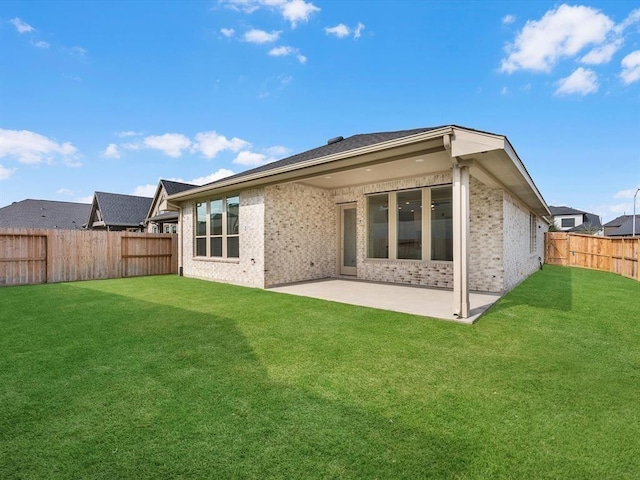 4203 Chloe Ridge Ln, Fulshear, TX 77441 - rear view of house featuring brick siding, a lawn, a fenced backyard, and a patio area