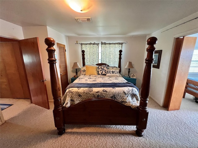 bedroom with visible vents and carpet flooring