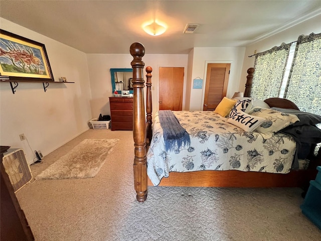 bedroom with visible vents and carpet flooring