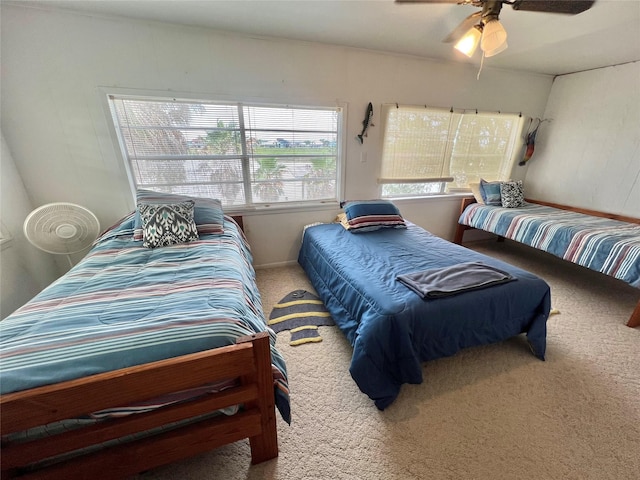bedroom featuring ceiling fan and carpet