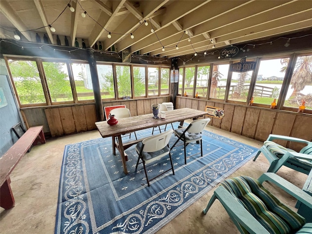 sunroom / solarium featuring plenty of natural light and concrete flooring