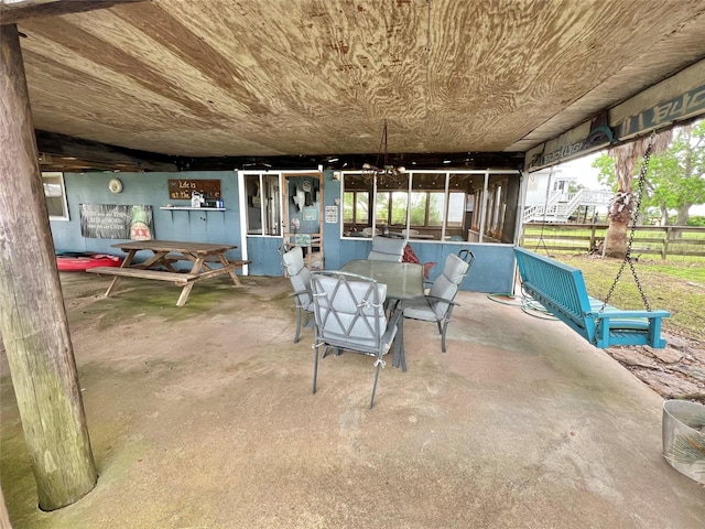 view of patio featuring fence and outdoor dining area