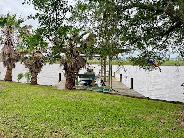 dock area featuring a lawn and a water view
