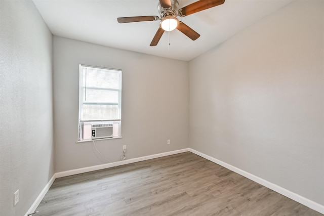205 Prune St, La Marque, TX 77568 - empty room featuring wood finished floors, cooling unit, a ceiling fan, and baseboards