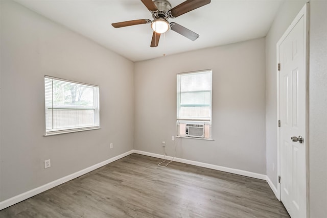 205 Prune St, La Marque, TX 77568 - unfurnished room featuring wood finished floors, ceiling fan, cooling unit, and baseboards