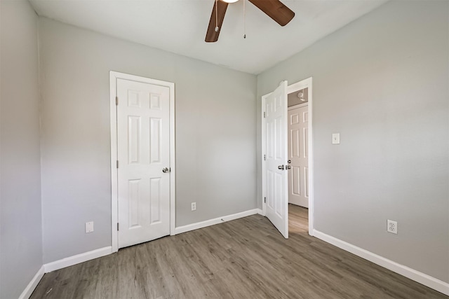 205 Prune St, La Marque, TX 77568 - unfurnished bedroom with ceiling fan, wood finished floors, and baseboards