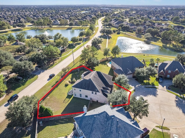 bird's eye view featuring a residential view and a water view