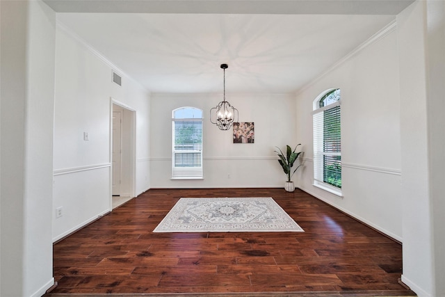 unfurnished dining area with a chandelier, ornamental molding, and a healthy amount of sunlight