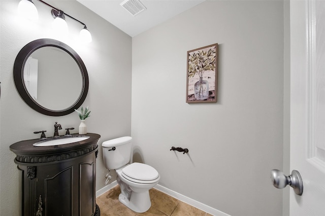 half bath featuring a sink, tile patterned floors, toilet, visible vents, and baseboards