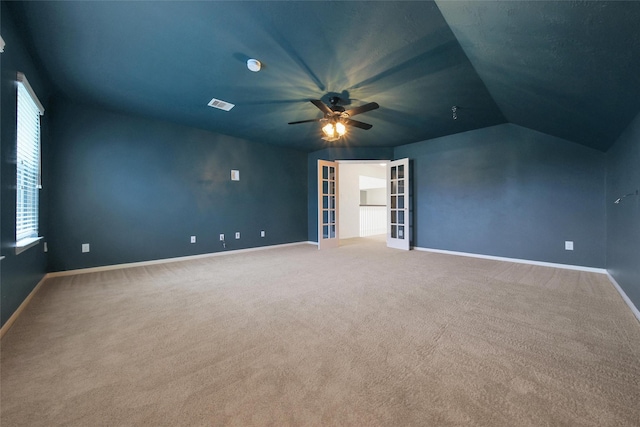 unfurnished bedroom featuring carpet floors, visible vents, baseboards, french doors, and lofted ceiling