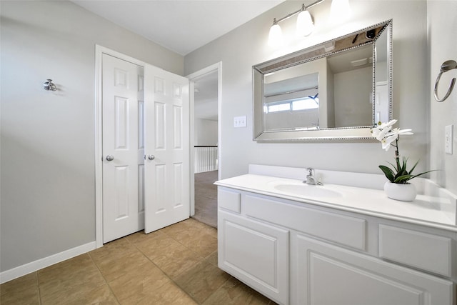 bathroom with tile patterned floors, vanity, and baseboards