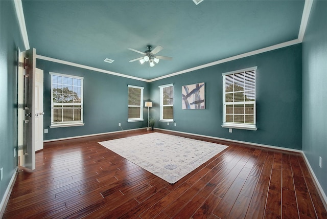 interior space with baseboards, visible vents, ornamental molding, and wood finished floors