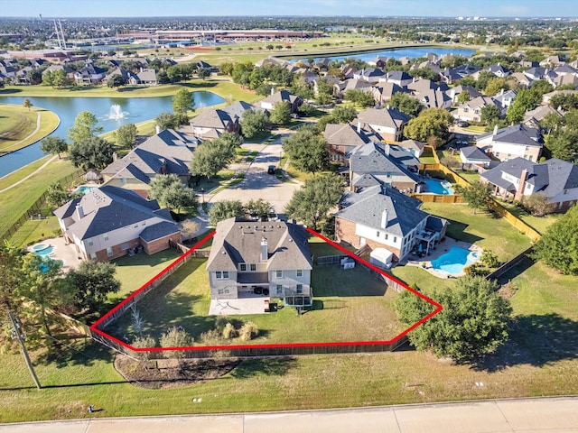drone / aerial view with a residential view and a water view