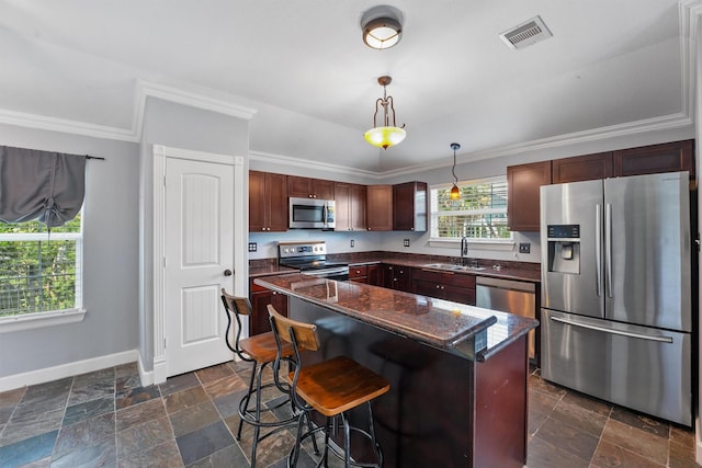 254 Debbie Ln, Dickinson, TX 77539 - kitchen featuring stainless steel appliances, a sink, baseboards, ornamental molding, and hanging light fixtures