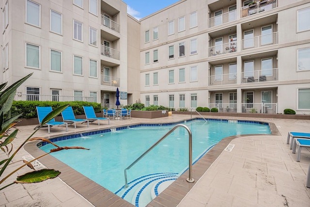 community pool with a patio area
