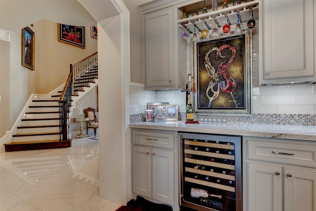 13906 Saint Marys Ln, Houston, TX 77079 - bar with beverage cooler, stairs, and tasteful backsplash