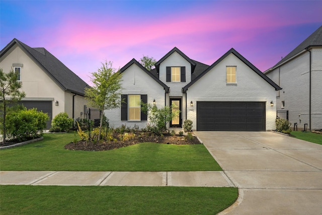 4623 Bridgewood Dr, Spring, TX 77386 - french country style house featuring driveway, a yard, brick siding, and an attached garage
