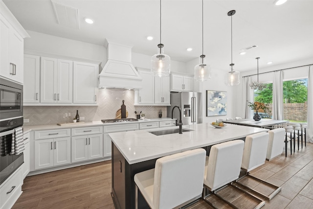 4623 Bridgewood Dr, Spring, TX 77386 - kitchen featuring stainless steel appliances, a sink, custom range hood, recessed lighting, and tasteful backsplash