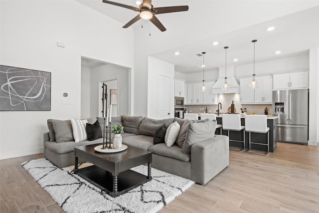 4623 Bridgewood Dr, Spring, TX 77386 - living room with a ceiling fan, recessed lighting, light wood finished floors, baseboards, and a high ceiling