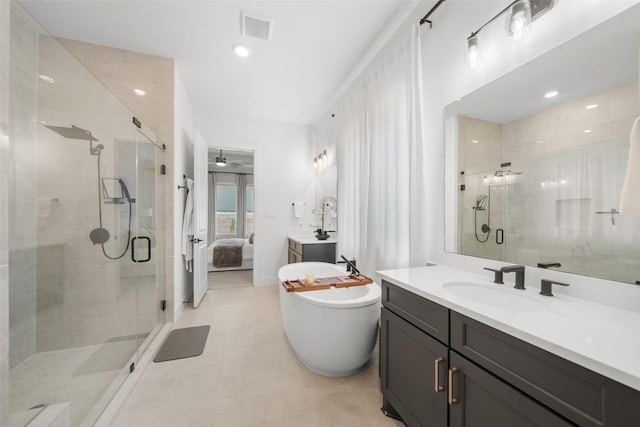 4623 Bridgewood Dr, Spring, TX 77386 - bathroom featuring a shower stall, a freestanding tub, tile patterned floors, and vanity