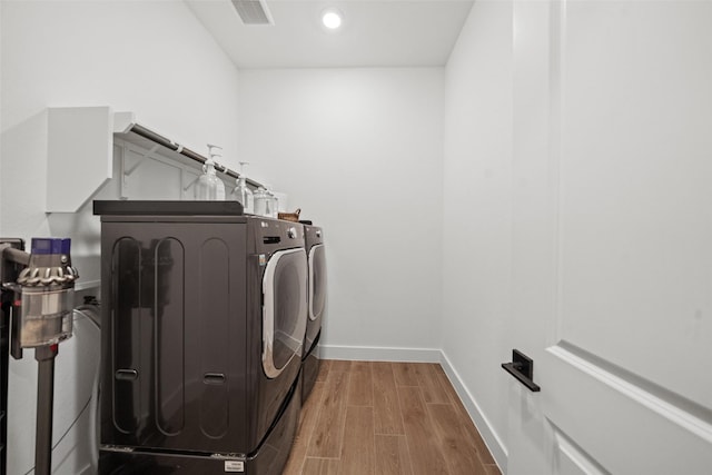 4623 Bridgewood Dr, Spring, TX 77386 - laundry area featuring washing machine and dryer, wood finished floors, baseboards, and recessed lighting
