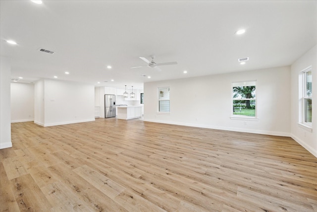 1935 Willow Rd, Wallis, TX 77485 - unfurnished living room with light wood finished floors, visible vents, ceiling fan, and recessed lighting