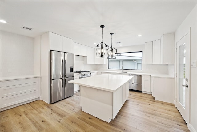 1935 Willow Rd, Wallis, TX 77485 - kitchen with stainless steel appliances, recessed lighting, white cabinets, light wood finished floors, and light countertops