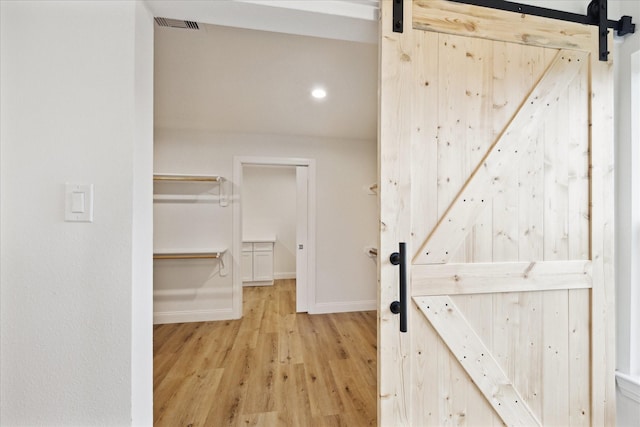 1935 Willow Rd, Wallis, TX 77485 - hallway with a barn door, wood finished floors, and baseboards