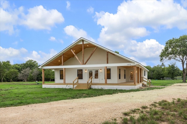 1935 Willow Rd, Wallis, TX 77485 - view of front of house featuring dirt driveway, a porch, and a front lawn