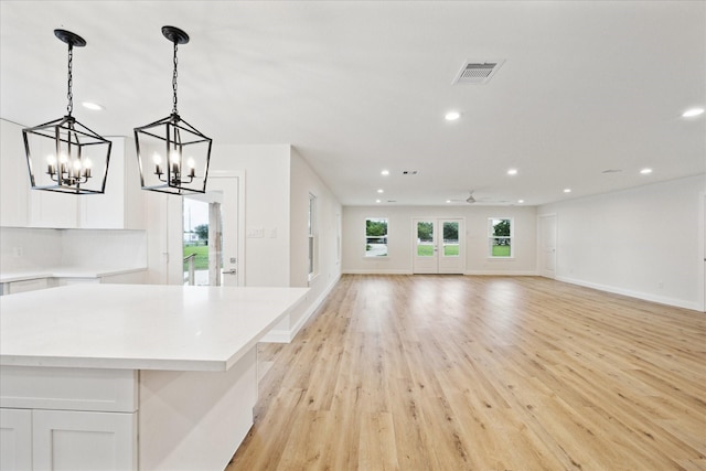 1935 Willow Rd, Wallis, TX 77485 - interior space featuring ceiling fan with notable chandelier, light wood-type flooring, visible vents, recessed lighting, and baseboards