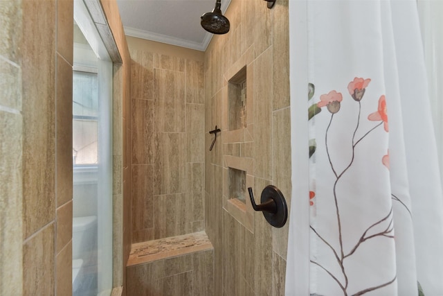 full bath with ornamental molding, toilet, and tiled shower