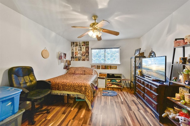 bedroom with a ceiling fan and wood finished floors