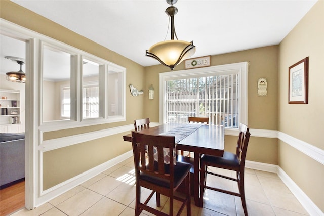 dining room featuring baseboards and light tile patterned flooring