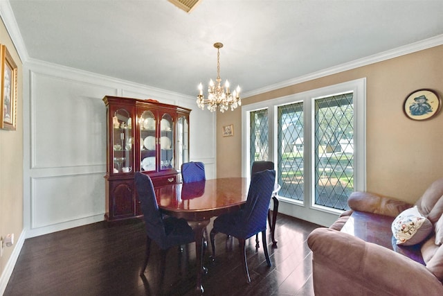 dining area featuring visible vents, baseboards, dark wood-style floors, a notable chandelier, and ornamental molding