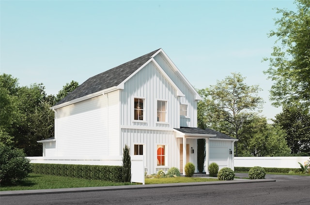 view of front of house with board and batten siding and roof with shingles