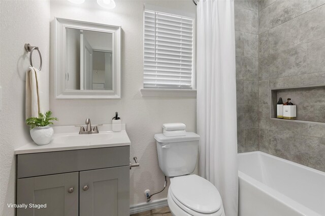full bathroom with shower / tub combo, vanity, and toilet