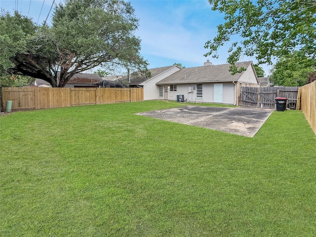 rear view of property featuring a chimney, a fenced backyard, a patio area, central AC, and a lawn