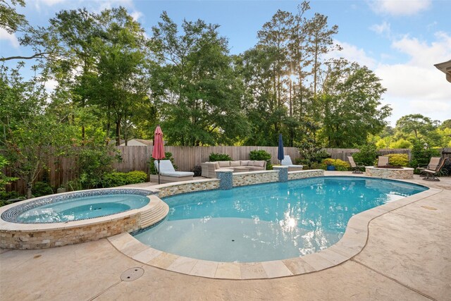view of swimming pool with a pool with connected hot tub, a patio, an outdoor living space, and a fenced backyard