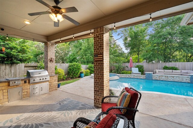 view of patio with ceiling fan, area for grilling, and a fenced backyard