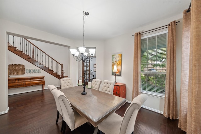 dining space with dark wood-style floors, stairs, and a chandelier