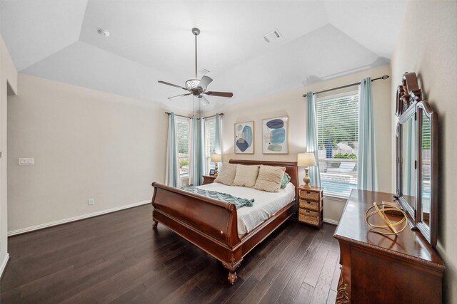 bedroom with dark wood finished floors, visible vents, a ceiling fan, and baseboards