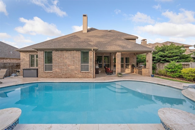 view of pool featuring a fenced in pool, an outdoor kitchen, a fenced backyard, and a patio area