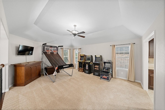 sitting room featuring carpet flooring, a raised ceiling, a ceiling fan, baseboards, and lofted ceiling