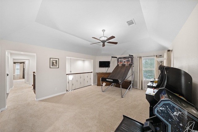 interior space with carpet floors, ceiling fan, baseboards, visible vents, and a tray ceiling
