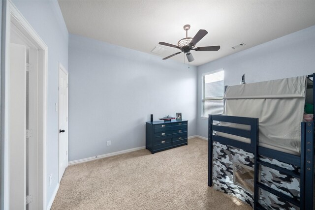 bedroom featuring baseboards, visible vents, ceiling fan, and carpet flooring