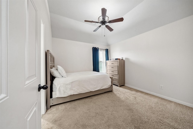 bedroom with a ceiling fan, vaulted ceiling, carpet, and baseboards