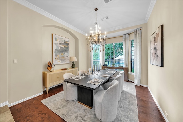 dining area with crown molding, baseboards, a notable chandelier, and visible vents