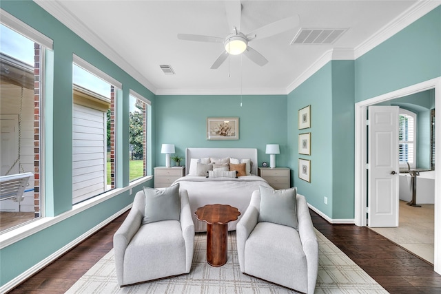 bedroom with crown molding, visible vents, and multiple windows